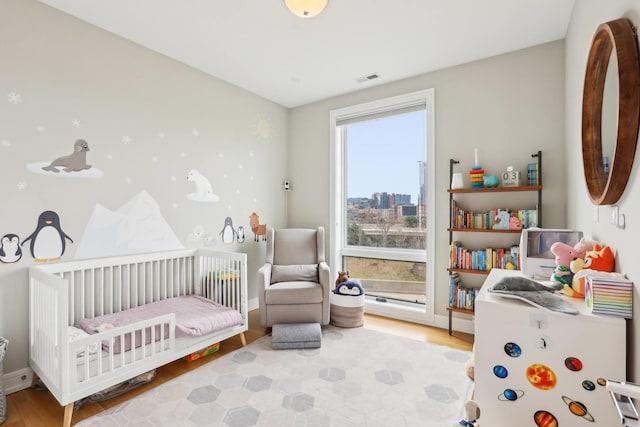 650 N Morgan St Unit 303, Chicago, IL 60642 - bedroom with a nursery area and wood finished floors