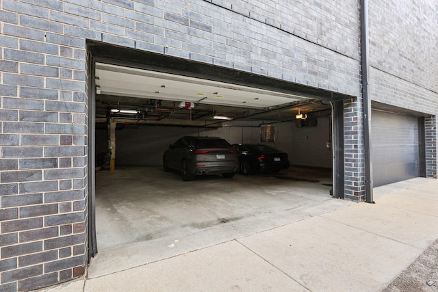 650 N Morgan St Unit 303, Chicago, IL 60642 - garage featuring a garage door opener and driveway