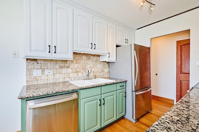 7033 N Kedzie Ave Unit 1706, Chicago, IL 60645 - kitchen with stainless steel appliances, white cabinetry, light wood-style flooring, tasteful backsplash, and green cabinets