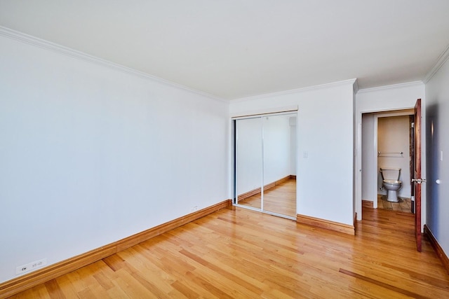 7033 N Kedzie Ave Unit 1706, Chicago, IL 60645 - unfurnished bedroom with light wood-type flooring, ornamental molding, and a closet