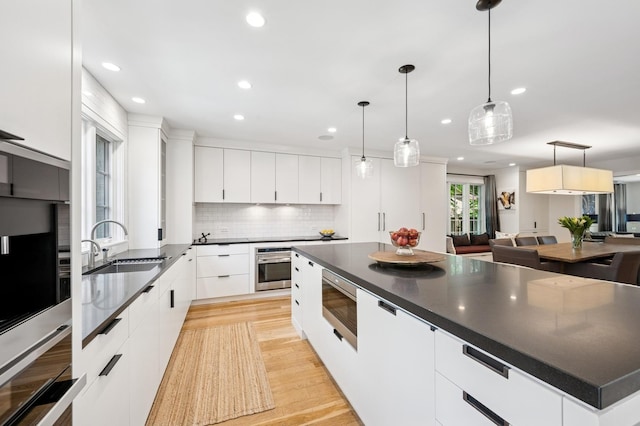 624 Laurel Ave, Wilmette, IL 60091 - kitchen with stainless steel appliances, dark countertops, modern cabinets, and recessed lighting