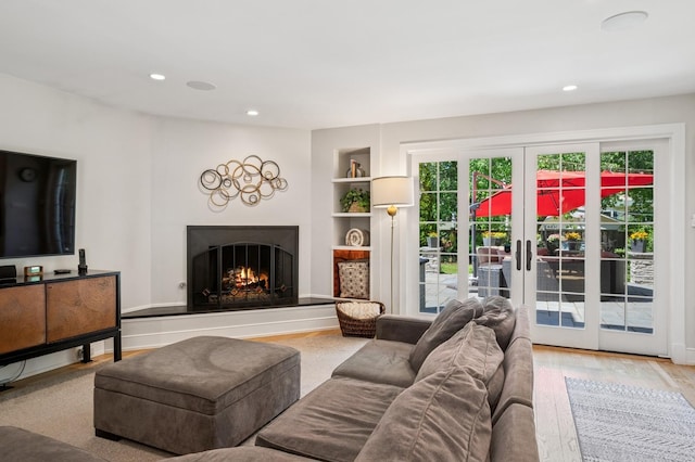 624 Laurel Ave, Wilmette, IL 60091 - living area featuring a warm lit fireplace, built in features, french doors, recessed lighting, and wood finished floors