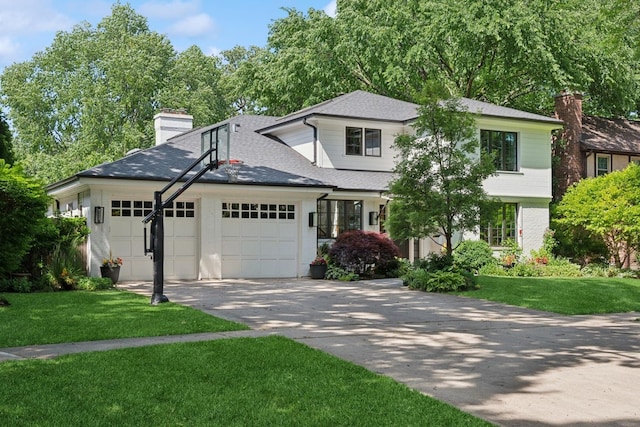 624 Laurel Ave, Wilmette, IL 60091 - view of front of home featuring an attached garage, a chimney, a front yard, roof with shingles, and driveway