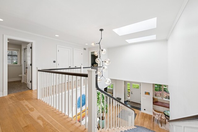624 Laurel Ave, Wilmette, IL 60091 - staircase with a skylight, wood finished floors, ornamental molding, and recessed lighting