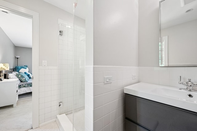 624 Laurel Ave, Wilmette, IL 60091 - bathroom featuring ensuite bathroom, tile walls, tiled shower, vanity, and wainscoting