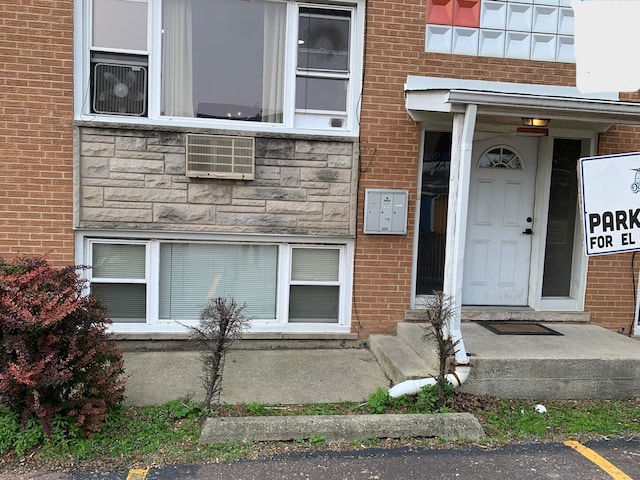 4115 S Harlem Ave Unit Ge, Stickney, IL 60402 - view of exterior entry featuring brick siding, stone siding, uncovered parking, and an AC wall unit