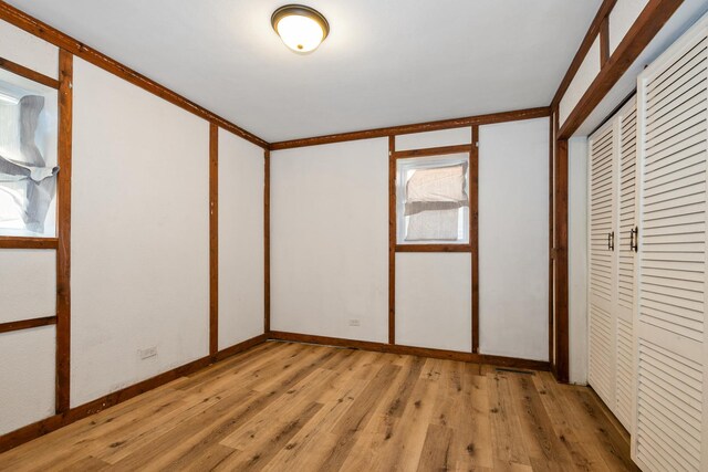 3645 177th Pl, Lansing, IL 60438 - unfurnished bedroom featuring light wood-style floors and a closet