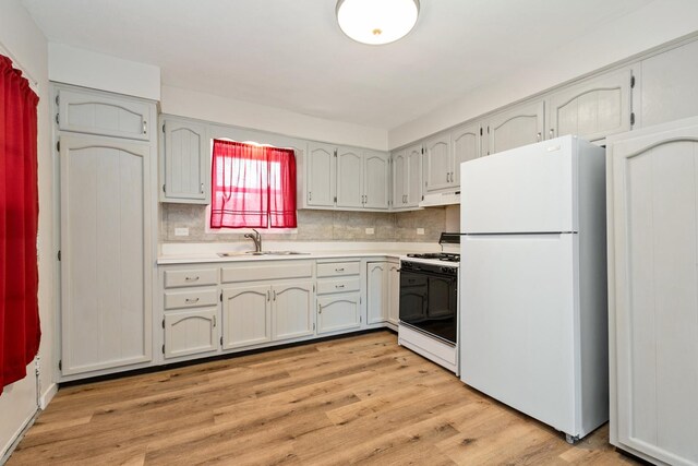3645 177th Pl, Lansing, IL 60438 - kitchen featuring white appliances, light countertops, light wood-style flooring, backsplash, and under cabinet range hood