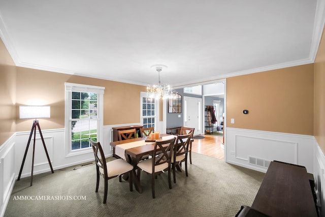4 Dryden Ct, Algonquin, IL 60102 - dining space with crown molding, wainscoting, a chandelier, light carpet, and a decorative wall