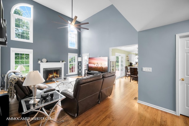4 Dryden Ct, Algonquin, IL 60102 - living area with a ceiling fan, high vaulted ceiling, a premium fireplace, wood finished floors, and healthy amount of natural light