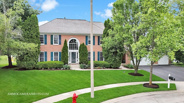 4 Dryden Ct, Algonquin, IL 60102 - view of front facade with a garage, driveway, a front yard, and brick siding
