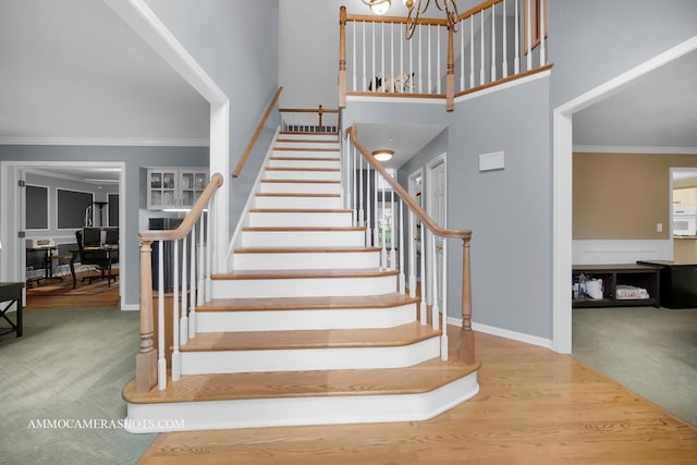 4 Dryden Ct, Algonquin, IL 60102 - staircase featuring ornamental molding, a chandelier, a towering ceiling, and carpet floors