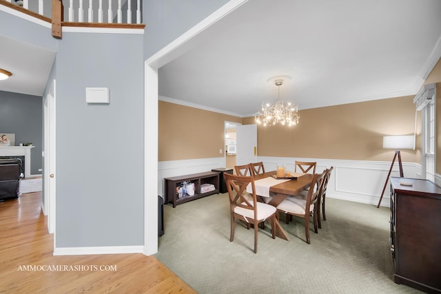 4 Dryden Ct, Algonquin, IL 60102 - dining room with ornamental molding, wainscoting, a chandelier, wood finished floors, and a premium fireplace