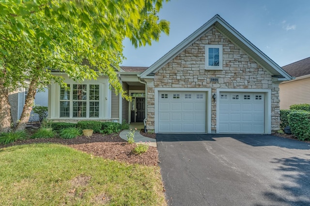 3866 Kingsmill Dr, Elgin, IL 60124 - view of front facade with stone siding, driveway, a garage, and a front lawn