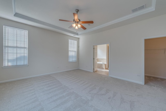 3866 Kingsmill Dr, Elgin, IL 60124 - unfurnished bedroom featuring a tray ceiling, crown molding, light carpet, a walk in closet, and ensuite bathroom