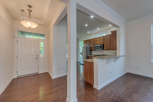 3866 Kingsmill Dr, Elgin, IL 60124 - kitchen with appliances with stainless steel finishes, crown molding, light stone countertops, dark wood-style flooring, and brown cabinets