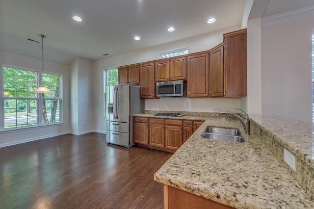 3866 Kingsmill Dr, Elgin, IL 60124 - kitchen with appliances with stainless steel finishes, brown cabinets, light stone counters, dark wood-style flooring, and decorative light fixtures