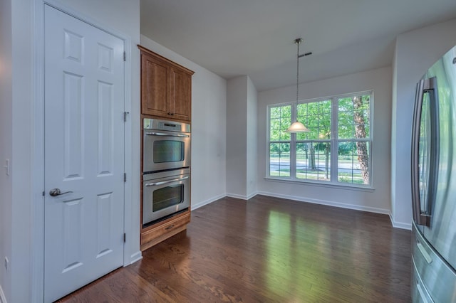 3866 Kingsmill Dr, Elgin, IL 60124 - kitchen with appliances with stainless steel finishes, dark wood finished floors, brown cabinetry, and hanging light fixtures