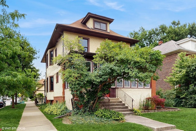 1150 S Oak Park Ave, Oak Park, IL 60304 - view of front of property with stucco siding, a front lawn, and brick siding