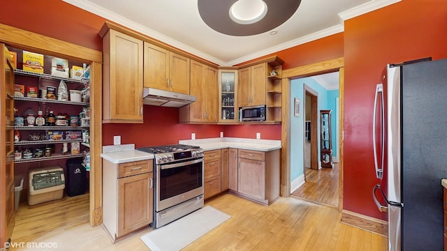 1150 S Oak Park Ave, Oak Park, IL 60304 - kitchen featuring stainless steel appliances, under cabinet range hood, ornamental molding, open shelves, and light wood finished floors