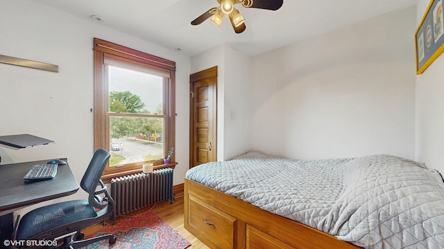 1150 S Oak Park Ave, Oak Park, IL 60304 - bedroom featuring radiator, light wood finished floors, a desk, and ceiling fan