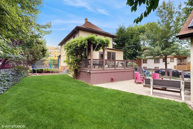 1150 S Oak Park Ave, Oak Park, IL 60304 - view of green lawn featuring a trampoline, a wooden deck, and a patio