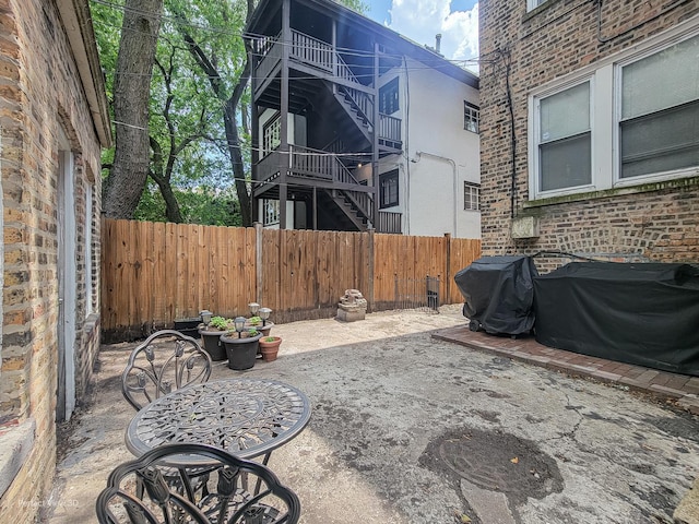 7612 N Rogers Ave Unit G, Chicago, IL 60626 - fenced backyard with area for grilling, a patio area, and stairway