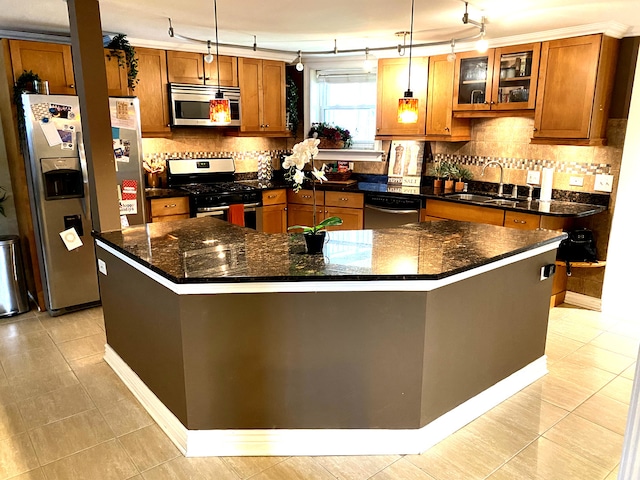 7612 N Rogers Ave Unit G, Chicago, IL 60626 - kitchen with stainless steel appliances, brown cabinetry, rail lighting, and tasteful backsplash