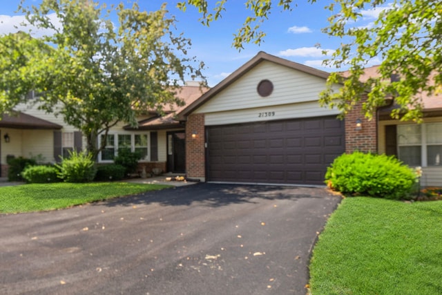 21309 Silktree Cir, Plainfield, IL 60544 - ranch-style house featuring brick siding, a garage, driveway, and a front yard