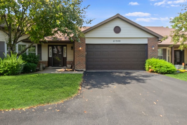 21309 Silktree Cir, Plainfield, IL 60544 - ranch-style house featuring brick siding, a garage, asphalt driveway, and a front yard