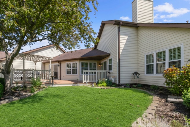 21309 Silktree Cir, Plainfield, IL 60544 - back of property featuring a wooden deck, a lawn, and a chimney