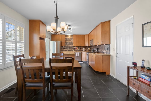 21309 Silktree Cir, Plainfield, IL 60544 - dining room with a chandelier and dark tile patterned flooring