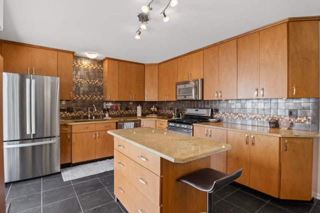 21309 Silktree Cir, Plainfield, IL 60544 - kitchen with stainless steel appliances, decorative backsplash, dark tile patterned flooring, a kitchen island, and brown cabinetry