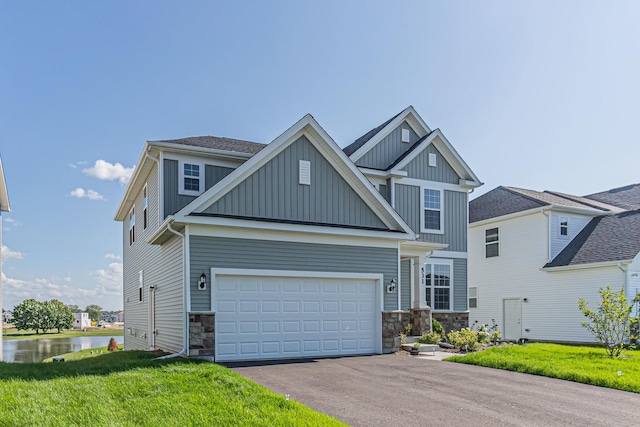 531 Alpine Dr, Algonquin, IL 60102 - craftsman-style home with board and batten siding, driveway, stone siding, a front yard, and a water view