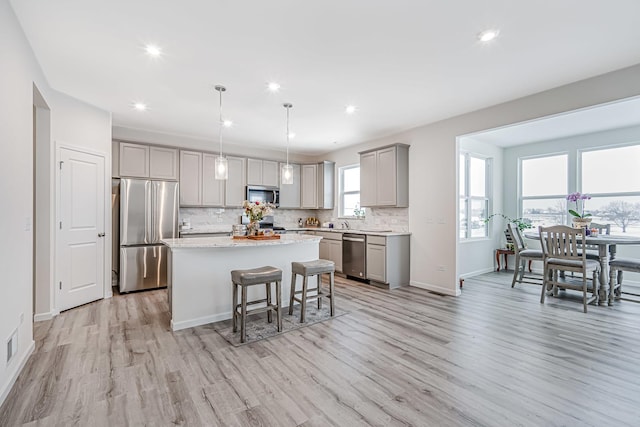 531 Alpine Dr, Algonquin, IL 60102 - kitchen featuring appliances with stainless steel finishes, gray cabinets, light wood-style floors, a center island, and recessed lighting
