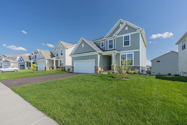 531 Alpine Dr, Algonquin, IL 60102 - craftsman-style house with stone siding, asphalt driveway, board and batten siding, a residential view, and a front yard