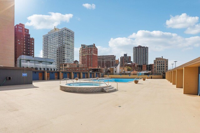 655 W Irving Park Rd Unit 2805, Chicago, IL 60613 - community pool with a hot tub and a view of skyline