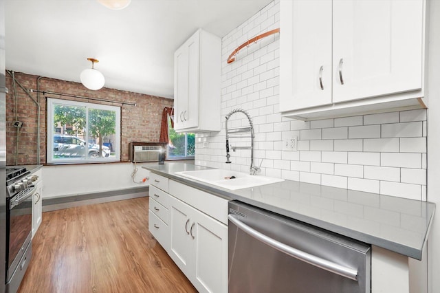 4113 W Cullom Ave Unit 1C, Chicago, IL 60641 - kitchen with stainless steel appliances, white cabinets, backsplash, and light wood-style floors
