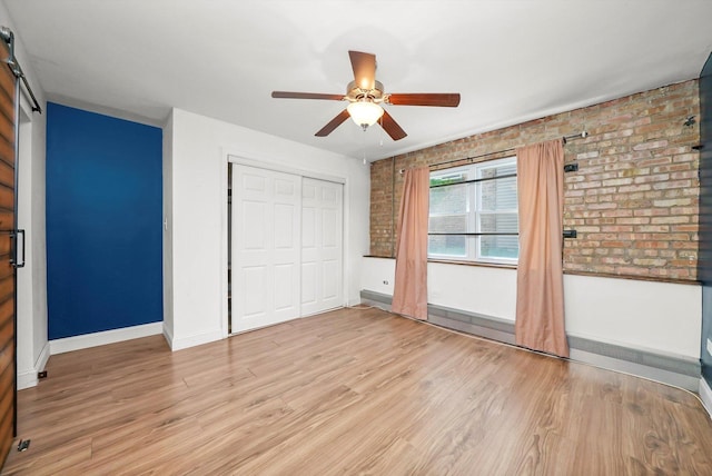 4113 W Cullom Ave Unit 1C, Chicago, IL 60641 - unfurnished bedroom featuring brick wall, light wood finished floors, a closet, and ceiling fan