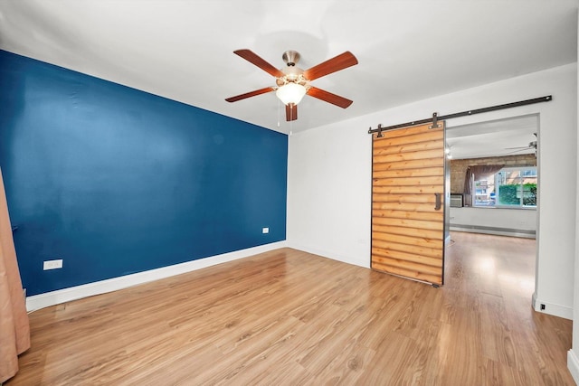 4113 W Cullom Ave Unit 1C, Chicago, IL 60641 - spare room with ceiling fan, a barn door, and wood finished floors