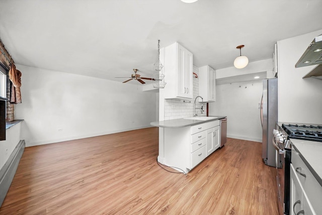 4113 W Cullom Ave Unit 1C, Chicago, IL 60641 - kitchen with appliances with stainless steel finishes, a ceiling fan, white cabinetry, light wood-style flooring, and tasteful backsplash