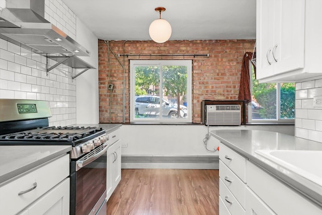 4113 W Cullom Ave Unit 1C, Chicago, IL 60641 - kitchen featuring stainless steel gas stove, extractor fan, light wood-style floors, tasteful backsplash, and white cabinetry