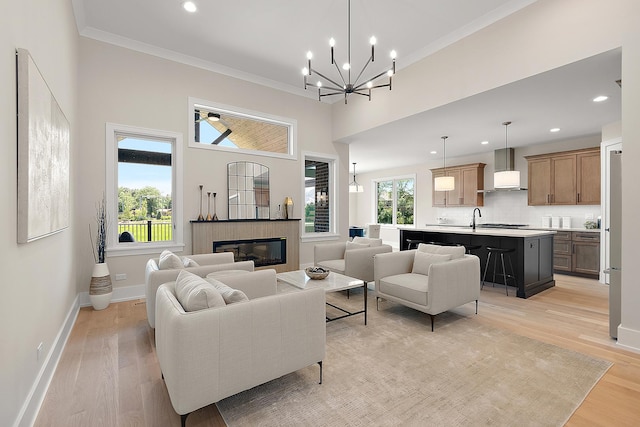 11155 Lizmore Ln Unit 35B, Orland Park, IL 60467 - living room featuring light wood-type flooring, a chandelier, a glass covered fireplace, recessed lighting, and ornamental molding