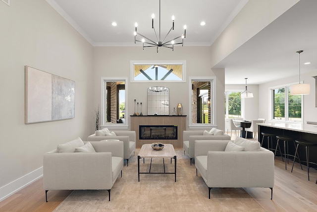 11155 Lizmore Ln Unit 35B, Orland Park, IL 60467 - living area featuring light wood-style floors, a chandelier, crown molding, recessed lighting, and a glass covered fireplace