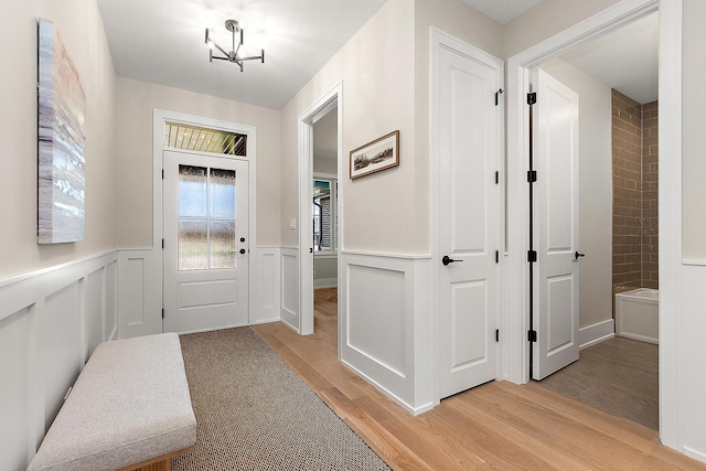 11155 Lizmore Ln Unit 35B, Orland Park, IL 60467 - entryway with light wood-style floors, a chandelier, and a wainscoted wall