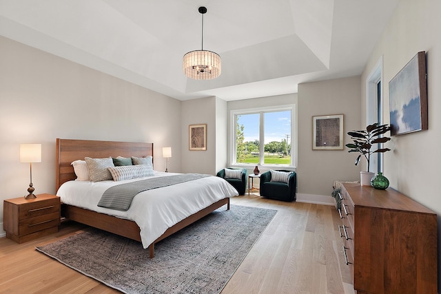 11155 Lizmore Ln Unit 35B, Orland Park, IL 60467 - bedroom with a raised ceiling, light wood-style flooring, and a chandelier