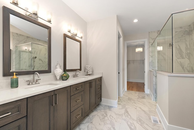 11155 Lizmore Ln Unit 35B, Orland Park, IL 60467 - bathroom featuring a marble finish shower, double vanity, marble finish floors, a walk in closet, and recessed lighting