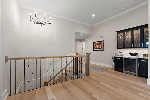 11155 Lizmore Ln Unit 35B, Orland Park, IL 60467 - indoor dry bar featuring wine cooler, a chandelier, light wood-type flooring, crown molding, and tasteful backsplash