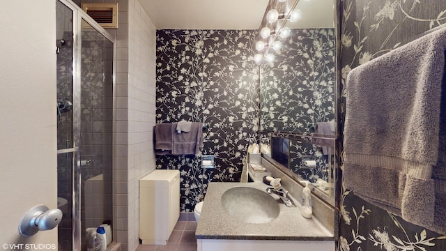 601 E 32nd St Unit 210, Chicago, IL 60616 - bathroom featuring wallpapered walls, vanity, a shower stall, and tile patterned floors