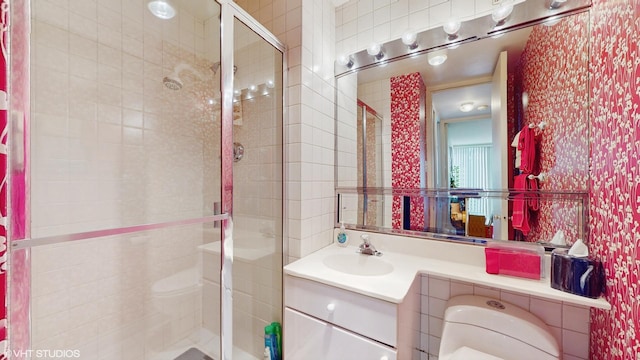 601 E 32nd St Unit 210, Chicago, IL 60616 - bathroom featuring a shower stall, vanity, and wallpapered walls